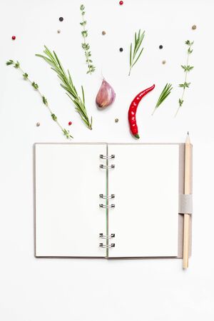 Flat lay overhead view blank notebook pages mockup text space invitation card on white background with greens herbs and spices. Menu or recipe book or food blog design with cooking ingredientsの写真素材
