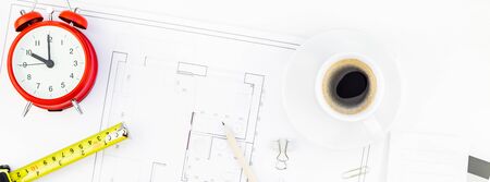 Creative flat lay overhead top view blueprint flat project plan hot coffee cup alarm clock and office supplies on decorator table workspace swatches tools and equipment background copy space conceptの写真素材