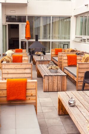 Outdoor restaurant terrace with wooden furniture in scandinavian style. Eco-friendly authentic design.の写真素材