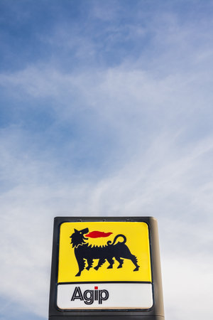 LYON, FRANCE - FEBRUARY 26, 2019: Agip, Italian oil and gas company logo on its gas service station in Lyon, France on blue sky background. In 2003, Eni acquired Agip Petroli S.p.Aのeditorial素材