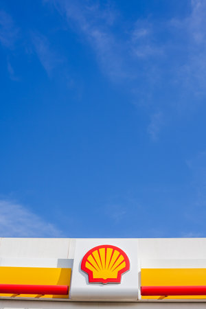 LYON, FRANCE - FEBRUARY 26, 2019: Royal Dutch Shell plc, British-Dutch oil and gas company logo on its gas service station in Lyon, France on blue sky backgroundのeditorial素材