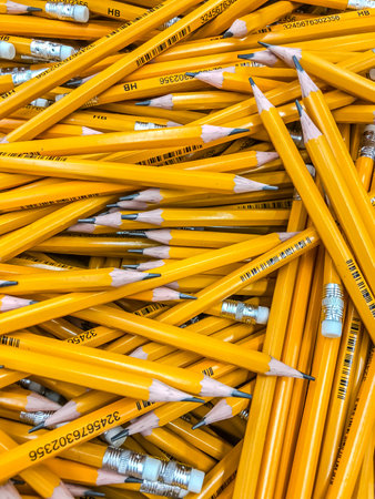 MOSCOW, RUSSIA - AUGUST 23, 2018: Koh-I-Noor yellow pencils heap in a supermarket. Top view. Mobile photoのeditorial素材