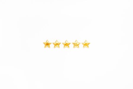 Customer Experience Feedback Concept. Golden five 5 stars, best excellent services rating for satisfaction isolated on white background. Top view, copy space for your textの写真素材