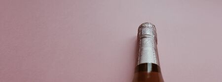 Bottle of rose champagne wine in minimal composition on pink background with copy space. Natural light. Template for tasting, degustation invitation card. Top viewの写真素材