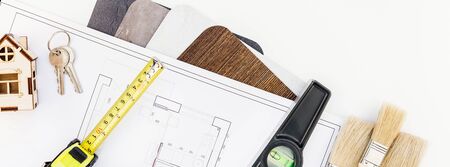 Creative flat lay overhead top view blueprint flat project plan and office supplies on decorator...