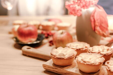 Thanksgiving Fall traditional homemade apple pies on wooden board for autumn holiday dining. Cozy...