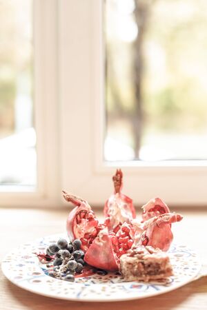 Dessert plate with fruits and sweets in front of window. Natural light. Still life compositionの写真素材