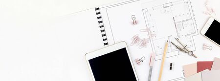 Blueprint flat project plan and office supplies on decorator table workspace. Swatches, tools,...