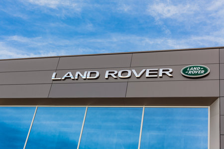 Land Rover brand logo on bright blue sky background located on its dealer office building in Lyon, France - February 23, 2020のeditorial素材
