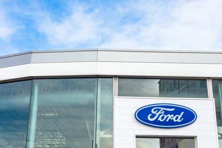 Ford Motor Company brand logo on bright blue sky background located on its car dealer office building in Lyon, France - February 23, 2020のeditorial素材