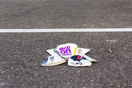 Disposable fast food cups garbage on asphalt street road. Ecological concept for reducing pollution....