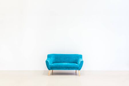 Minimal concept of living interior with bright blue sofa on white floor and background. Scandinavian style wall mockup.の写真素材