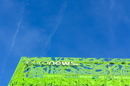 Euronews, european pay television news network brand logo on its headquarter office building located in eco-district Confluence. Blue sky background with copy space. Lyon, France - February 21, 2020のeditorial素材