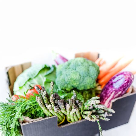 Fresh organic greens and vegetables safe contactless delivery during coronavirus Covid-19 pandemic outbreak. Box with local farmer grocery delivering left in the house doorway. Care package, donationの写真素材