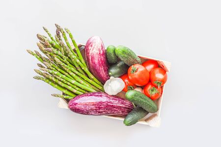 Fresh organic vegetables in eco friendly wooden box flat lay, top view on gray background with copy space. Sustainable lifestyle. Zero waste, plastic free, Care package, donation conceptの写真素材