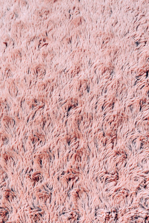 Closeup plush textile pink abstract background. Fabric texture.