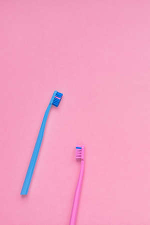 Teeth hygiene and oral dental care products on color pink and blue background with copy space. Toothbrushes Flat lay, top view composition, mockupの写真素材