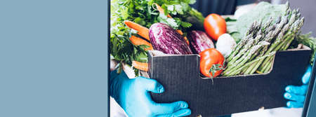 Fresh organic greens and vegetables delivery during coronavirus Covid-19 pandemic outbreak. Man...