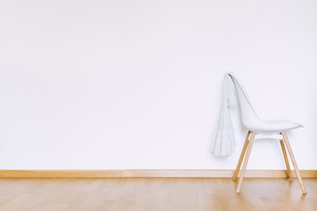 Indoors flat wall mockup with Clothes on Chair in minimalist style. Earthy Neutrals Tones Background. Interior in airy light style with wooden floorの写真素材