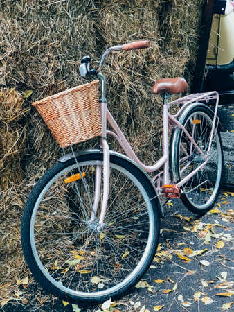 Bicycle with basket leaning to hay wall as cottagecore style and alternative eco-friendly conceptの写真素材