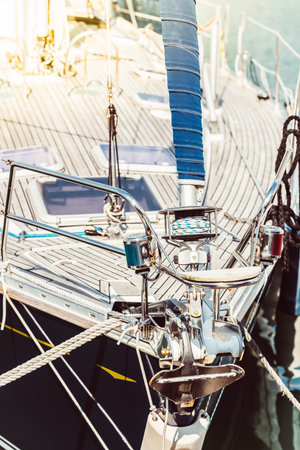 Sailboat deck with focus on rigging and sunlight reflection, background,