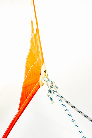 Sailing boat ropes tied to an orange sail, abstract composition, background,の写真素材