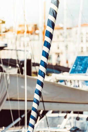 Sailboat mast with blue and white stripes in marina, nautical theme,の写真素材