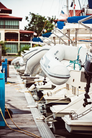 Sailboats moored at marina with inflatable dinghies, nautical theme, background,の写真素材