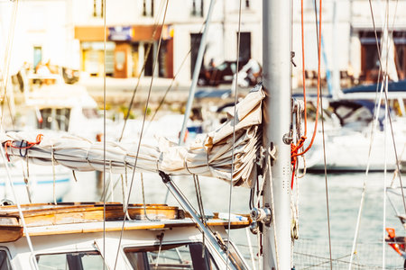 Sailboat mast with ropes in bustling marina on sunny day, background,の写真素材