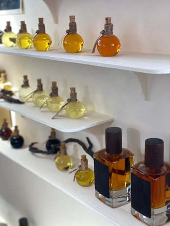Various perfume bottles on display shelf in a store setting with elegant presentation. Mobile photoの写真素材