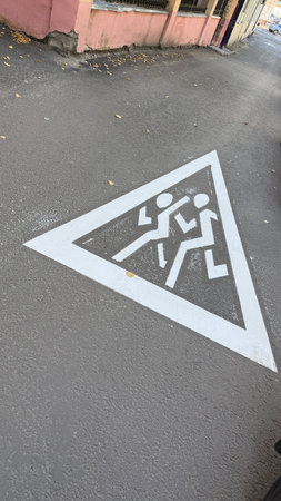 Pedestrian crossing sign painted on urban street pavement conveying safety message. Mobile photoの写真素材