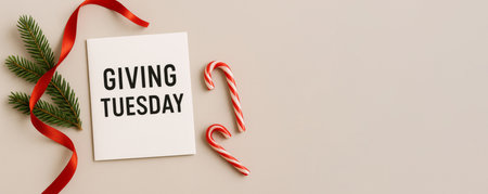 Giving Tuesday holiday card with candy canes and red ribbon on beige background, AI Generatedの素材