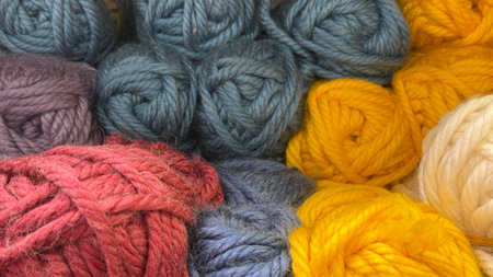 Colorful yarn skeins arranged in vibrant display, showcasing texture and variety in knitting...