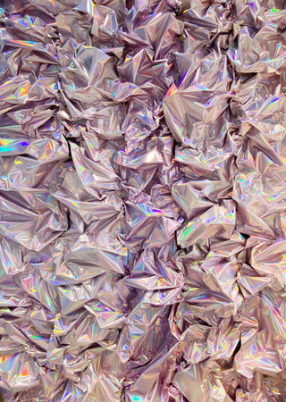 Crinkled holographic foil texture with iridescent colors creating abstract shiny background. Mobile photoの写真素材
