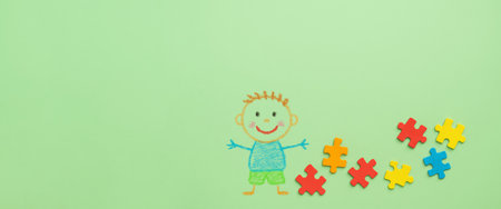 Autism awareness day concept with colorful puzzle pieces and child drawing, AI generatedの素材