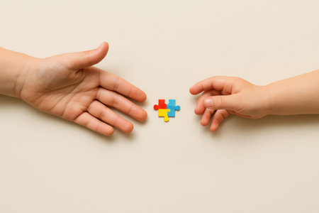 Autism Awareness Day puzzle concept with two hands holding colorful puzzle piece, AI generatedの素材