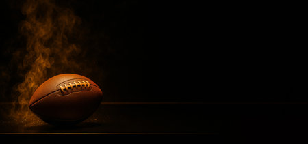 American football on dark smoky background with copy space, AI generatedの素材
