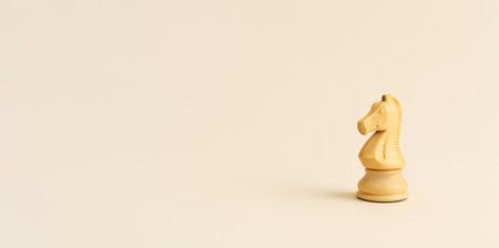 Chess knight piece on plain beige background, business concept, copy space, AI Generatedの素材