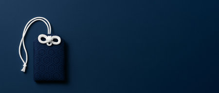 Japanese New Year omamori charm on dark blue background, AI generatedの素材