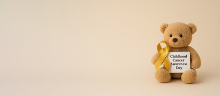 Childhood cancer awareness day teddy bear with yellow ribbon and text space, AI generatedの素材