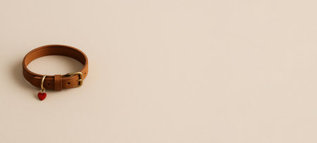 Brown leather pet collar with red heart charm on plain background, AI generatedの素材