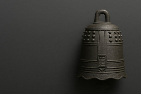 Japanese New Year decor temple bell on dark background, AI generatedの素材