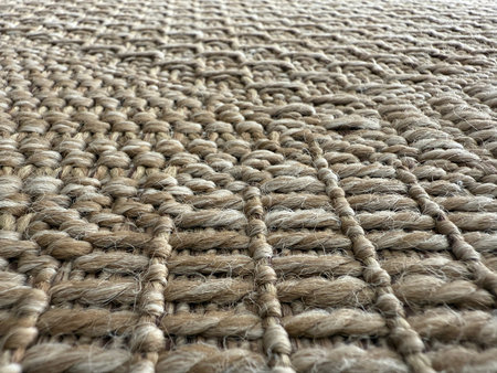Close-up of woven jute texture, showcasing intricate pattern suitable for natural background. Mobile...