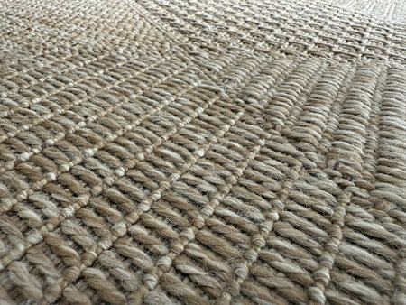 Close-up woven rope surface texture with intricate patterns, suitable as natural background or...