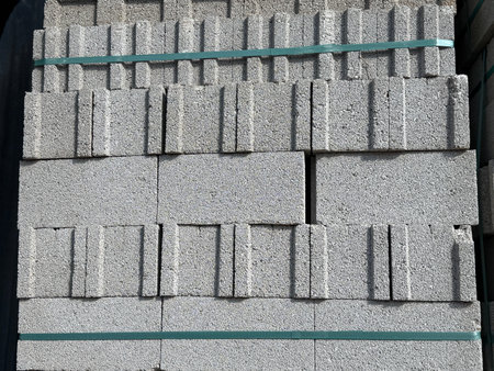 Concrete blocks stacked in a pile creating an industrial construction material background. Mobile...