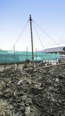 worker man use tripod metal steel for laboursaving device carry cement beamの写真素材