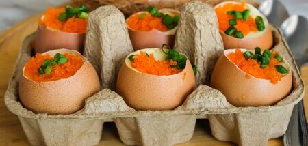 six steam eggs decorate with orange ebiko in panel paperの写真素材