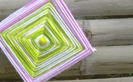 beauty square knitting wool multicolor handmade. bamboo tree wooden textured  backgroundの写真素材