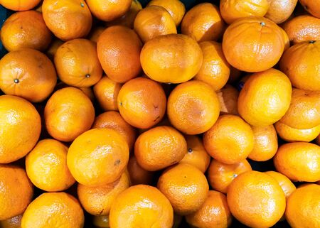 group of fresh orange fruit sell in market thailand. vitamin C from natural vegan food.の写真素材