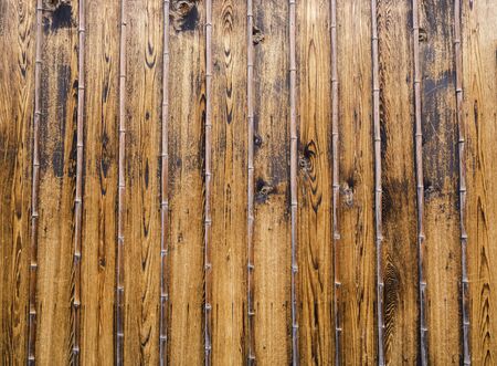 golden dark plank wooden wall japanese natural style backgroundの写真素材